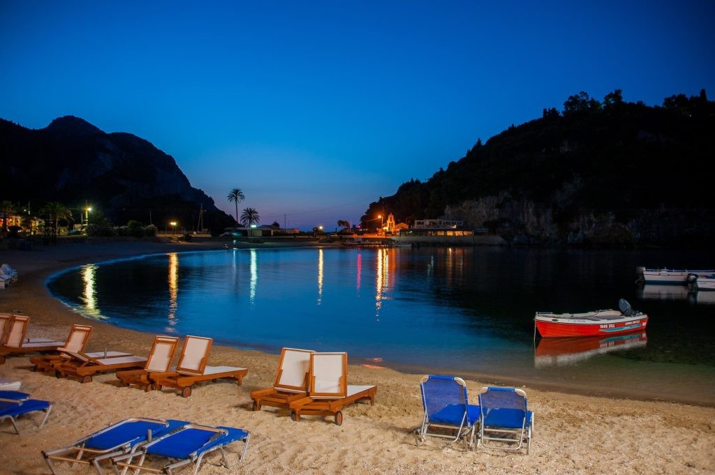 Paleokastritsa shore at night with twinkling lights