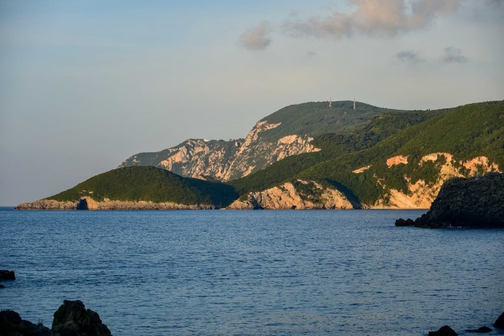 Golden-hour light on Paleokastritsa cliffs and sea