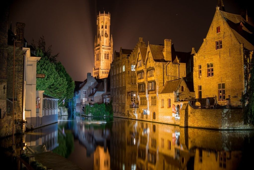 Rozenhoedkaai at night with canal reflections and the Belfry in the background