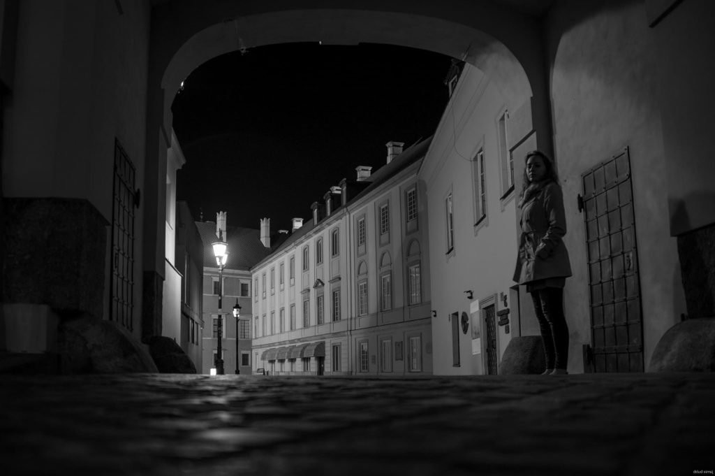 Cobbled street in Warsaw’s Old Town at night.