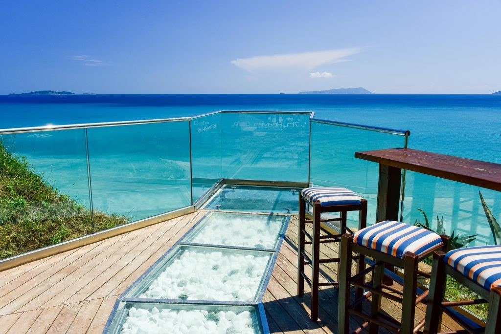 Sunset view over turquoise sea from a cliff-top bar in Corfu