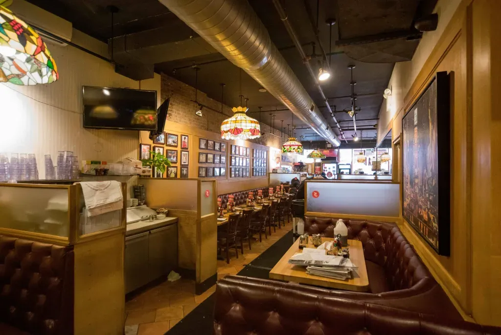 Interior of Sarge’s Deli and Diner with leather booths and a classic deli counter.