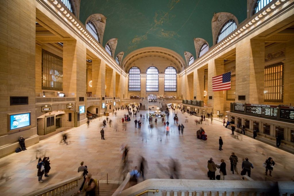 Grand Central Terminal’s main concourse with a bustling crowd and a celestial ceiling.