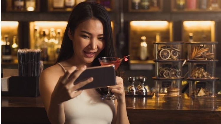Solo traveler enjoying a drink at the bar